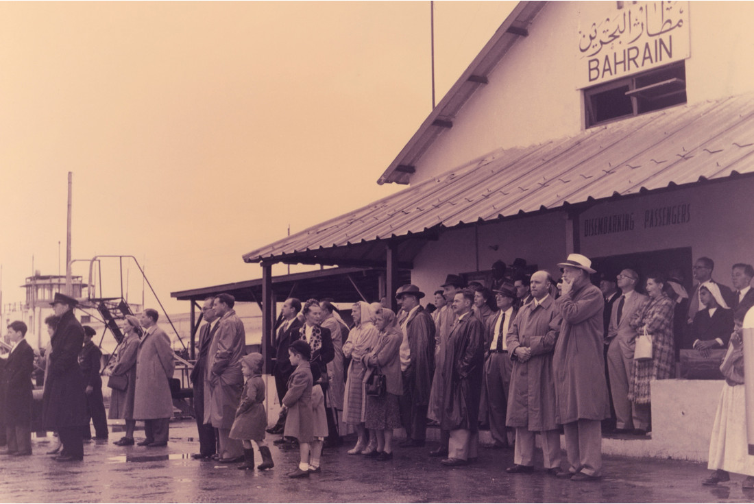 Friends and relatives wait for their loved ones to disembark at the old airport in Muharraq