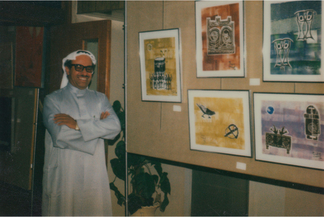 Nasser Al Yousif with some of his paintings