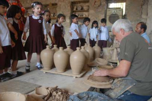 Mr Chrisogelos does a demonstration for schoolchildren in A'ali 